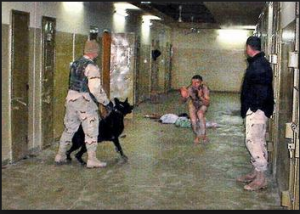 US military forces enjoying torturing Iraqis prisoners in Abu Graib jail in Iraq in 2004