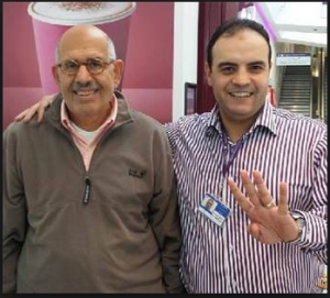 Mohamed El Baradei with a muslim brotherhood restaurant owner in london raising 4 fingers of Rabaa armed sit in